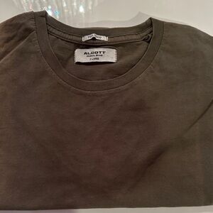 Alcott Men's Dark Green Short Sleeve Tee. Sun line down the shirt